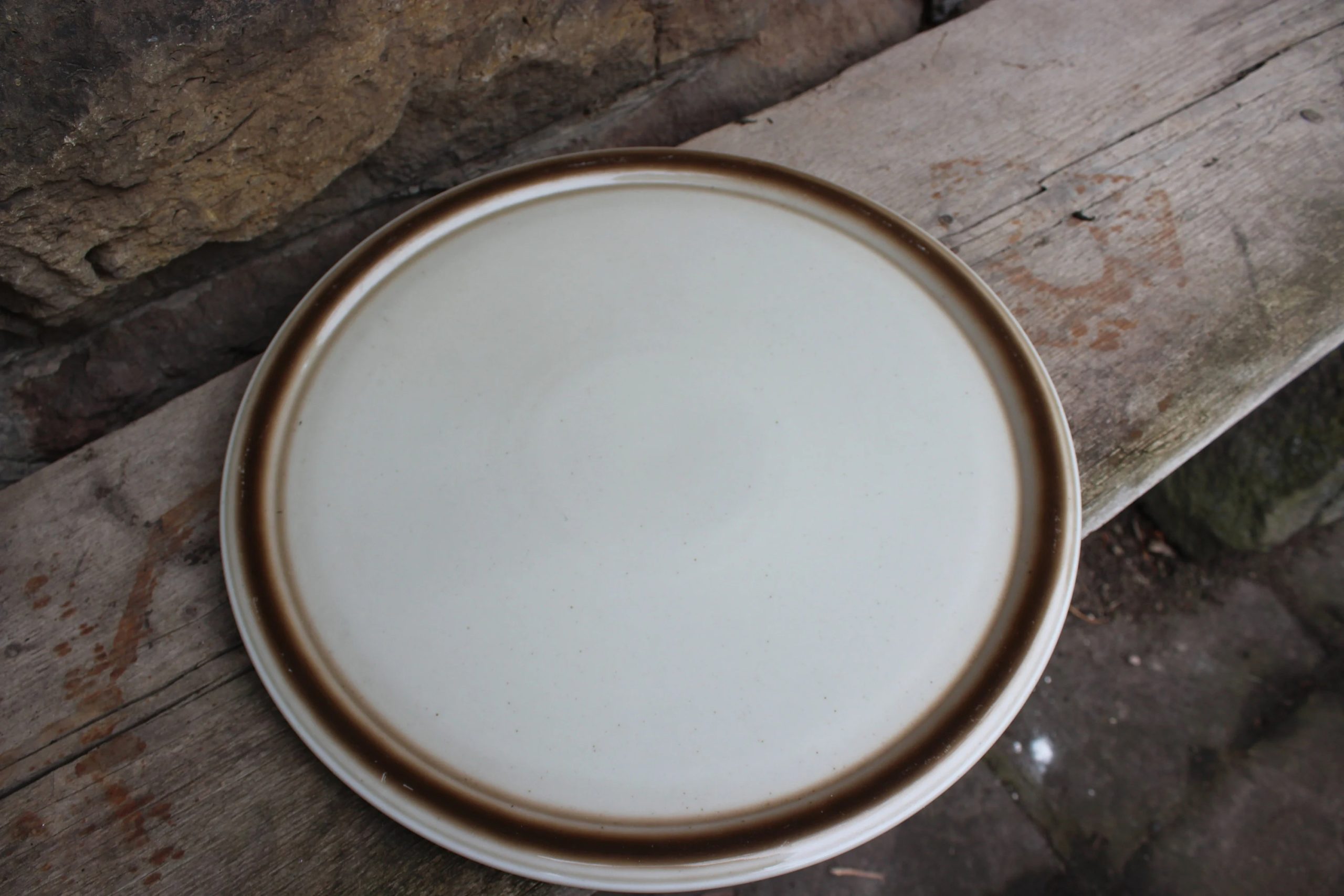 Simple cream-colored ceramic dinner plate