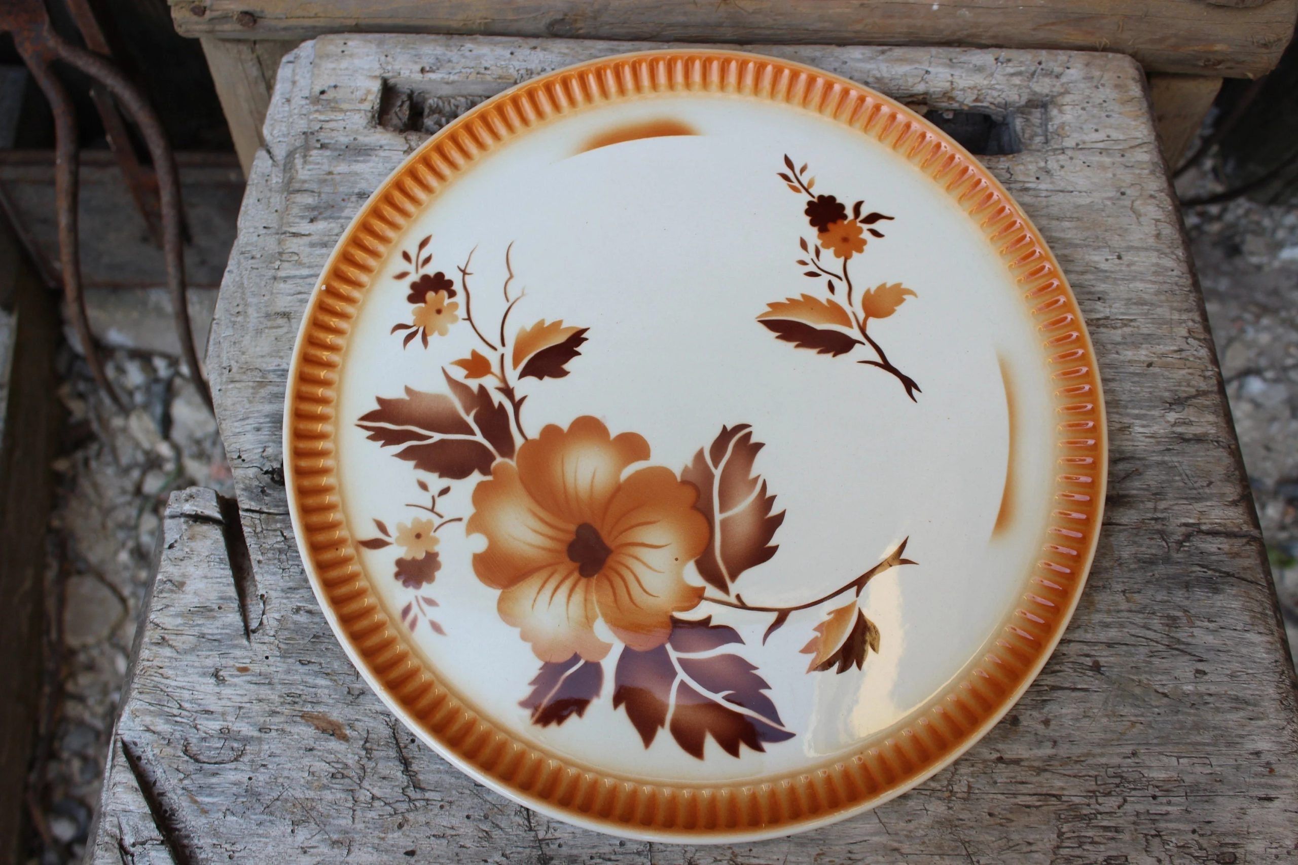 Vintage style ceramic dinner plate with plant and flower design